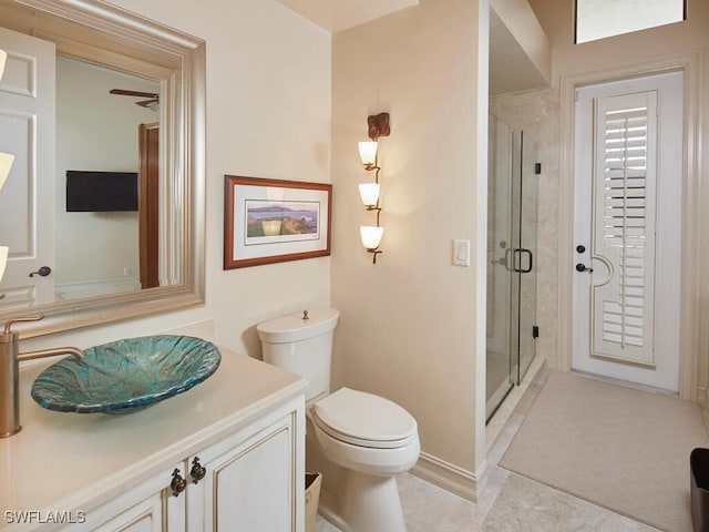 bathroom featuring a shower with door, toilet, and vanity