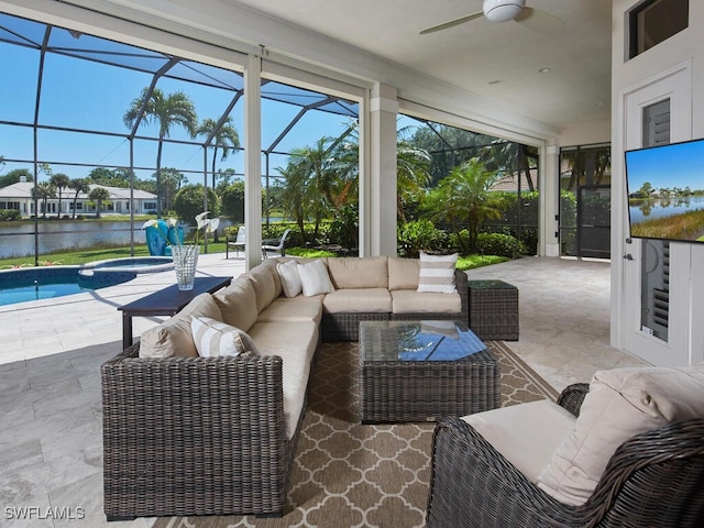 sunroom / solarium with ceiling fan and a water view