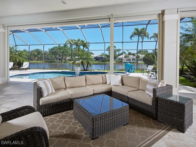 view of patio / terrace featuring a lanai, an outdoor living space, and a water view