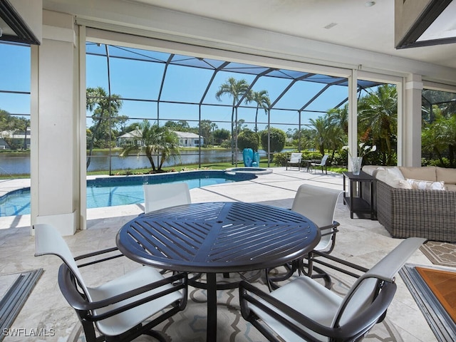 view of pool featuring a patio area, a lanai, an outdoor living space, and a water view