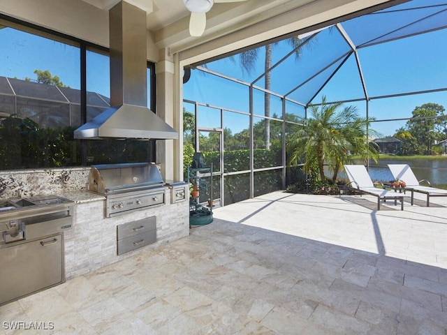 view of patio with glass enclosure, an outdoor kitchen, a water view, and a grill