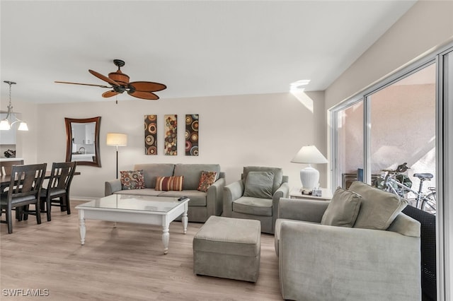 living room with ceiling fan and light wood-type flooring