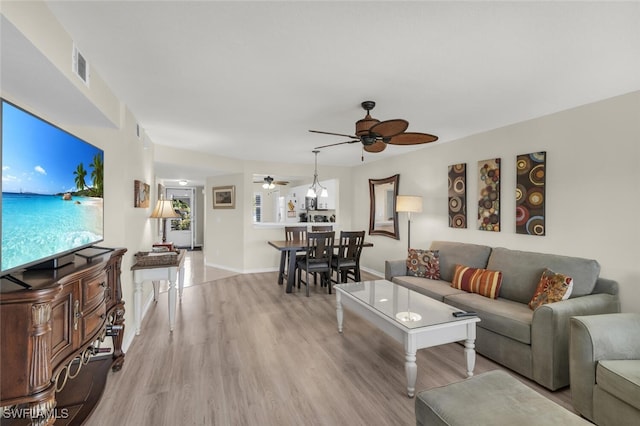 living room featuring ceiling fan and light wood-type flooring