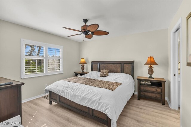 bedroom with light hardwood / wood-style floors and ceiling fan