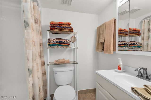 bathroom featuring tile patterned floors, walk in shower, vanity, and toilet