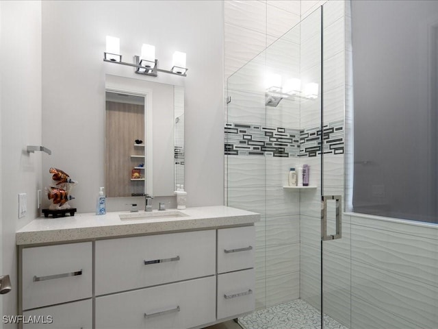 full bathroom featuring a shower stall and vanity