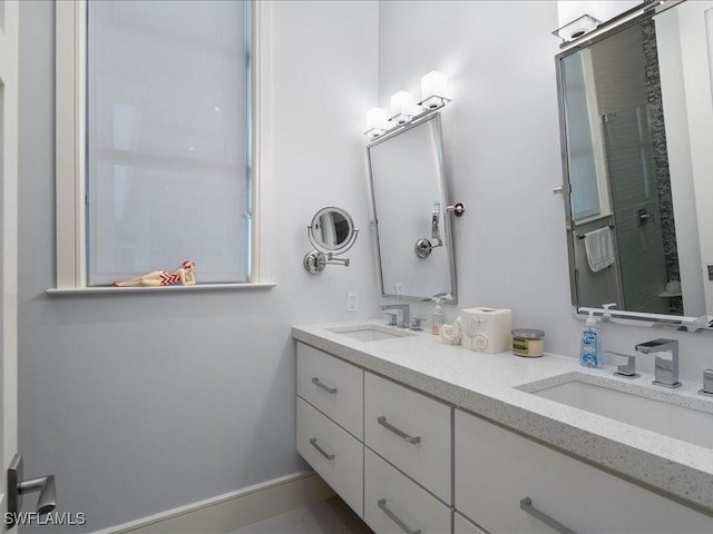 full bath featuring double vanity and a sink