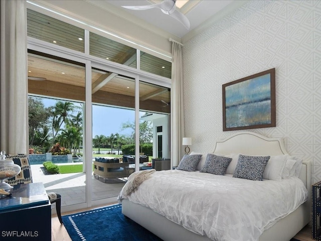 bedroom featuring access to outside and wallpapered walls