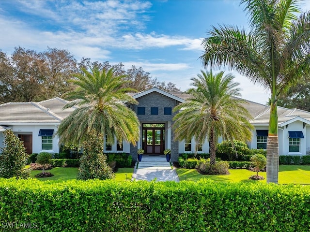 view of front facade featuring french doors and a front yard