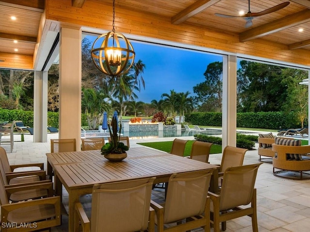 sunroom / solarium featuring wooden ceiling, a wealth of natural light, beam ceiling, and an inviting chandelier