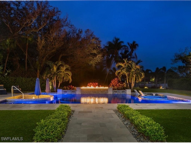 pool at twilight featuring an outdoor pool