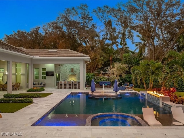 pool featuring an in ground hot tub, a bar, and a patio area