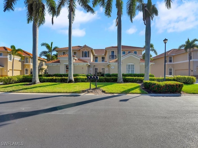 mediterranean / spanish-style house with a front lawn