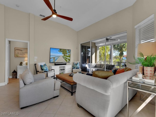 living room featuring light tile patterned floors and high vaulted ceiling