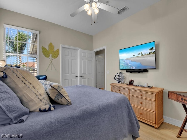 bedroom with light hardwood / wood-style floors and ceiling fan