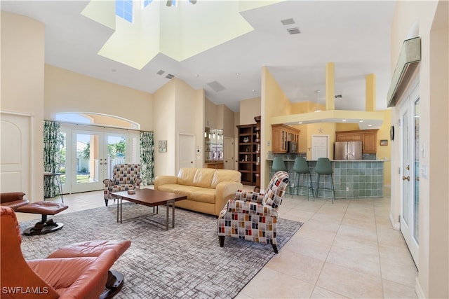 living room featuring light tile patterned flooring, a high ceiling, and french doors