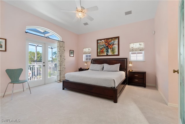 bedroom with ceiling fan, access to exterior, light carpet, and french doors