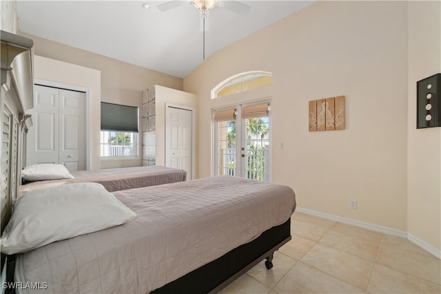 tiled bedroom with high vaulted ceiling, ceiling fan, access to outside, and multiple windows