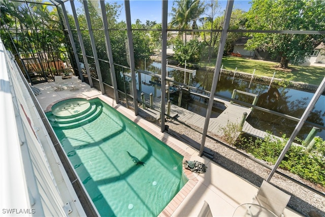 view of swimming pool with a water view and a patio area