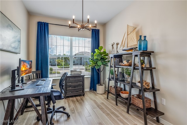 home office with light wood-type flooring and a notable chandelier