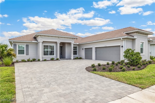 view of front of house featuring a garage and a front lawn