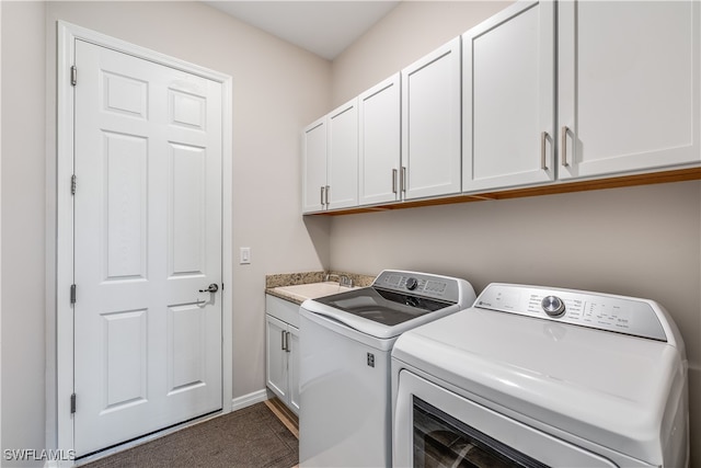 washroom with washer and clothes dryer, cabinets, and sink