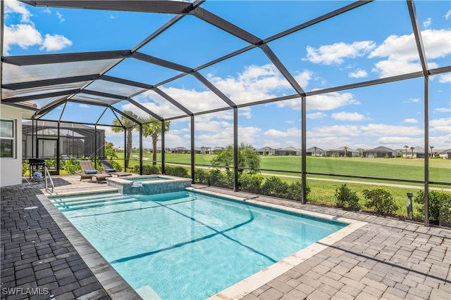 view of swimming pool with a patio area, a lanai, and an in ground hot tub