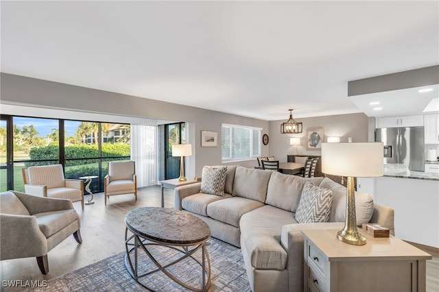 living room featuring light hardwood / wood-style floors and a notable chandelier