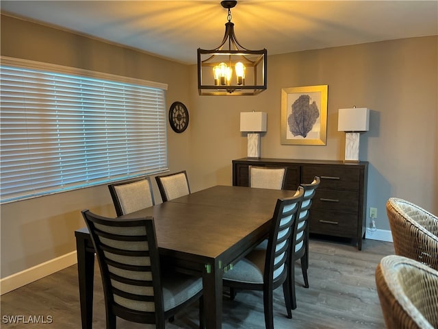 dining area featuring a chandelier and wood-type flooring