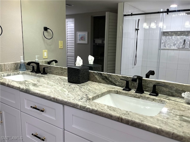 bathroom with vanity and a tile shower