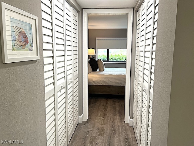 corridor with dark hardwood / wood-style flooring