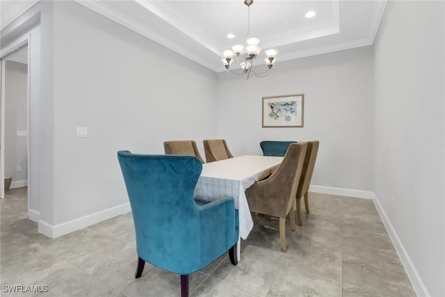 dining room featuring a raised ceiling, a notable chandelier, and crown molding