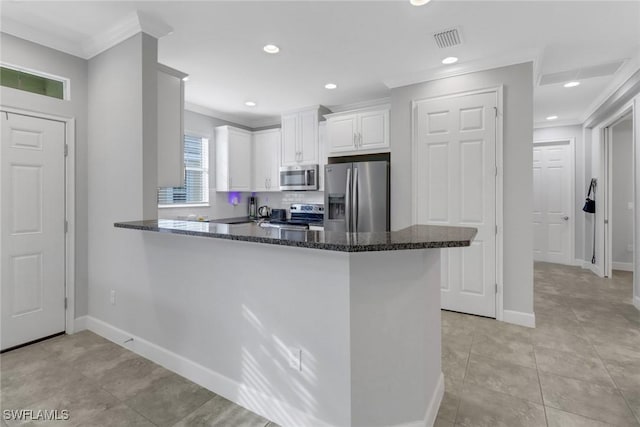 kitchen with kitchen peninsula, white cabinetry, crown molding, and stainless steel appliances