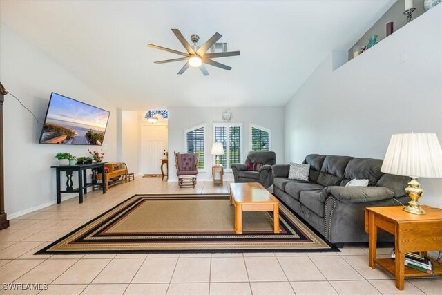 tiled living room with vaulted ceiling and ceiling fan