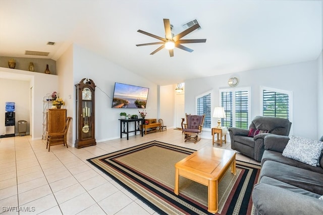 living room with ceiling fan, light tile patterned flooring, and lofted ceiling