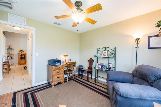 tiled bedroom featuring ceiling fan