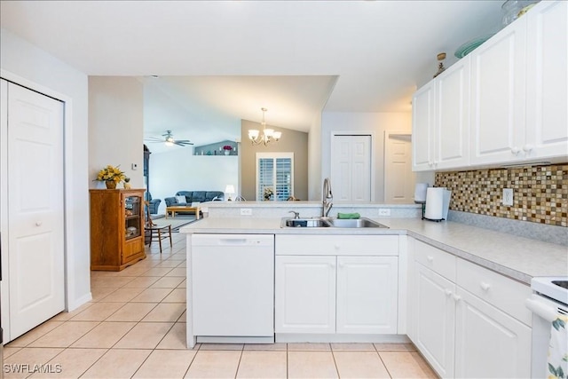 kitchen featuring kitchen peninsula, sink, pendant lighting, and white appliances