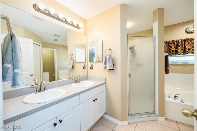 bathroom with tile patterned flooring, vanity, and shower with separate bathtub