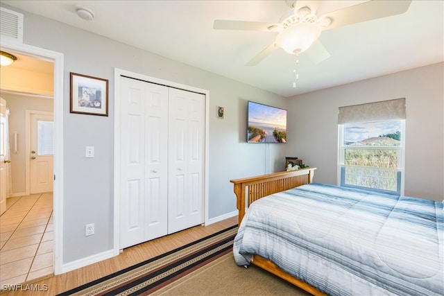 bedroom with a closet, ceiling fan, and light hardwood / wood-style flooring