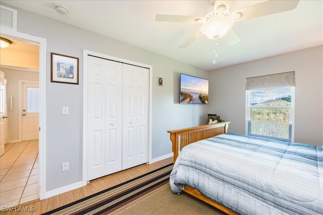 bedroom with ceiling fan and a closet