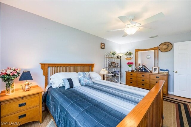 bedroom with hardwood / wood-style floors and ceiling fan