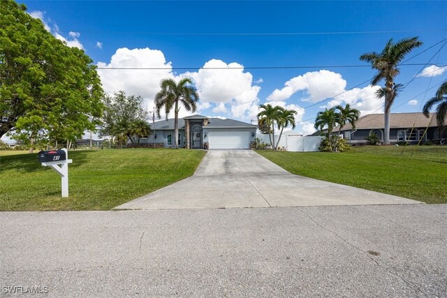 view of front of house featuring a front yard and a garage