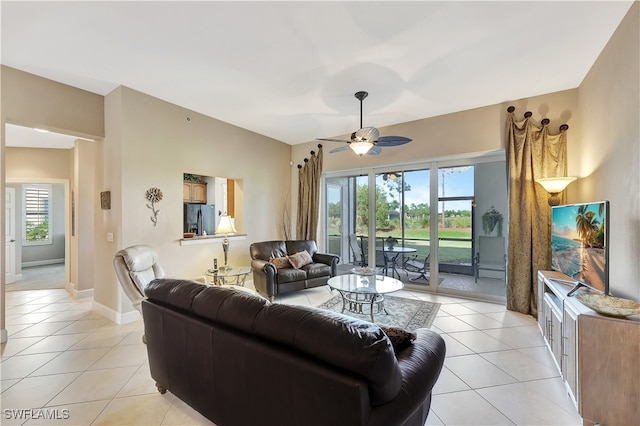 tiled living room with plenty of natural light and ceiling fan