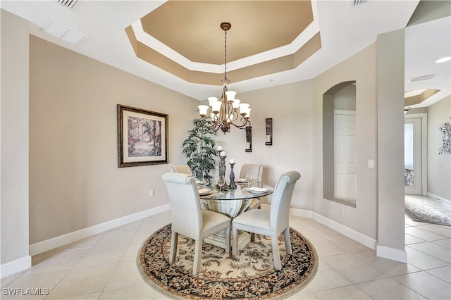 dining area with a chandelier, light tile patterned floors, and a tray ceiling