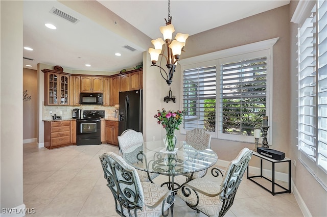 tiled dining space with plenty of natural light and a notable chandelier