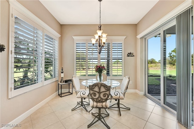 dining area featuring plenty of natural light, light tile patterned floors, and a chandelier