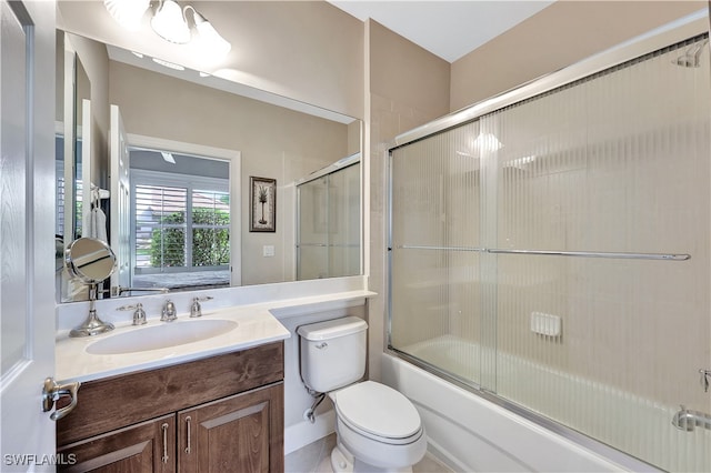 full bathroom with shower / bath combination with glass door, vanity, and toilet