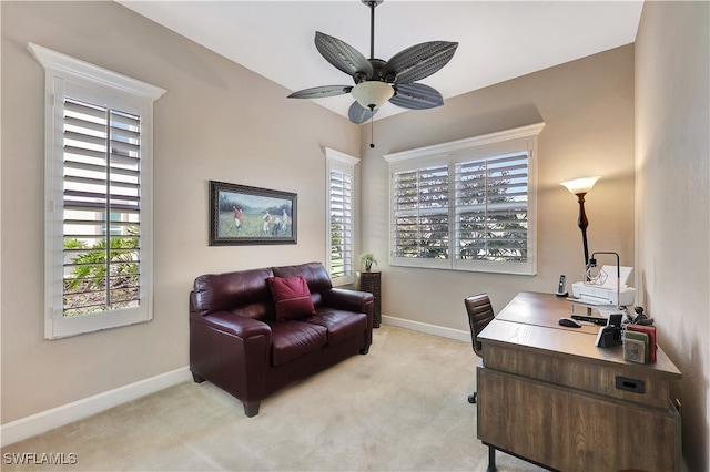 office area with ceiling fan, a healthy amount of sunlight, and light carpet