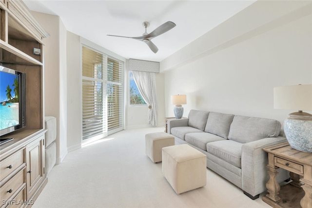 carpeted living room featuring ceiling fan