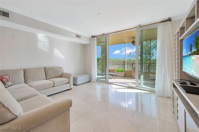 living room featuring expansive windows, a healthy amount of sunlight, and light tile patterned floors